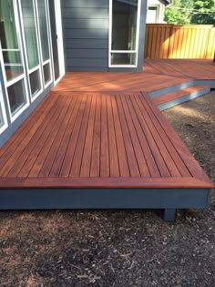 a wooden deck in front of a house