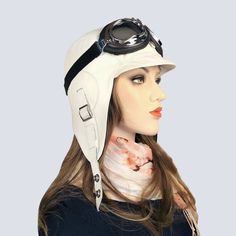 "Women's white leather aviator hat/cap, pilot-style helmet, timeless style, with goggles if desired, unisex hat. Ideal for an aviator look, convertible car riding or bicycle rides, daily use, an aviator steampunk costume, party, bachelorette party, etc. Made of soft white leather and black nylon lining, which is comfortable for spring, summer and fall. ADJUSTABLE STRAPS on each side allow the hat to be attached under the chin and upwards, with snaps fasteners. A buckle at the back of the hat all White Adjustable Leather Hat, Adjustable White Leather Hat, Adjustable Windproof Aviator Hat, White Visor Hat For Travel, White Travel Visor Hat, Aviator Helmet, Aviator Costume, Black Goggles, Aviator Cap