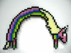 an image of a cross stitch unicorn with a rainbow on it's head and tail