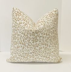 a leopard print pillow sitting on top of a white table