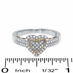 Everything you love about her can be expressed through this romantic 10K two-tone gold heart-shaped ring. The gleaming white gold design is covered in round diamonds and accented by rose gold swirls inside the shank and a matching heart outline at the center. Be prepared to turn heads in this 1/3 ct. t.w. diamond fashion favorite. White Brilliant Cut Heart Ring For Anniversary, White Heart-shaped Diamond Ring, White Diamond Ring With Diamond Accents For Valentine's Day, White Diamond Cut Heart Ring For Anniversary, Valentine's Day White Diamond Cut Ring, White Diamond-cut Heart Ring, White Diamond Cut Heart Ring For Promise, White Diamond Heart Ring With Vs Clarity, White Heart Diamond Ring Vs Clarity