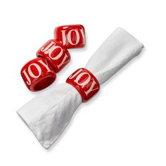 two red and white candy candies with the word joy written on them, sitting next to each other