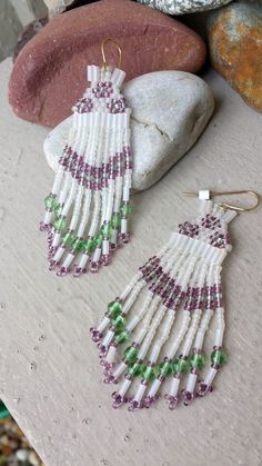 Long Beaded Fringe Earrings.  Comanche Brick Stitched Glass Beaded Earrings in the colors of White Frost, Peridot Green & Purple Amethyst.   Earrings are made entirely of glass beads:  Seed Beads, Bugle Beads and 4mm Peridot Green round glass beads.  Gold Plated Surgical steel ear wires for pierced ears. Length: 3 1/4" (from top of ear wire to bottom of earring).   Width: 1" at widest when worn on the ear. Handcrafted by artist Hanan Hall.   Ships First Class USPS (includes domestic tracking #) from a smoke-free environment. Thank you for visiting www.etsy.com/shop/thefoxandfilly  -  Please favorite my shop as I am continually adding unique & lovely pieces you may not want to miss!  And additional jewelry items in your order qualify for shipping discounts! Please review Shop Policies BEFOR White Beaded Fringe Jewelry For Crafting, Traditional Purple Beaded Earrings, Artisan Purple Beaded Earrings, Artisan Beaded Purple Earrings, Artisan White Jewelry With Bead Caps, Beaded Earrings Native, Native American Earrings, Peridot Green, Bugle Beads