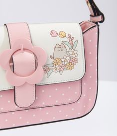 This cute handbag, in collaboration with Pusheen, features a charming pink color with white polka dots and a playful Pusheen print on the front. Made of durable leatherette, this bag also boasts an adjustable shoulder strap for comfortable carrying. The daisy belt buckle design on the front adds a touch of whimsy, while the snap button closure keeps your items secure. Inside, you'll find one zipper pocket and one slip pocket, perfect for keeping your belongings organized.Available while supplies Cute Handbag, Cute Handbags, Printed Handbags, Pusheen, Backpack Purse, Cutie Patootie, Belt Buckle, White Polka Dot, Vintage Pink