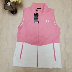 Pink And White Fitted, Full Zip, Cold Gear Sleeveless Jacket Vest. Zippered Pockets. White Sleeveless Top With Pockets, White Sports Tops With Pockets, White Sleeveless Outdoor Vest, Sporty Spring Outerwear Vest, White Sleeveless Outdoor Outerwear, Casual White Vest Outerwear, White Casual Vest For Spring, White Outdoor Vest For Fall, Casual Pink Sleeveless Outerwear