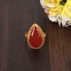 Natural Red Sardonyx Ring, Statement Ring, Handmade Brass Jewelry, Gold Plated Ring, Wedding Ring, Gift For Her D E S C R I P T I O N  : Metal: Brass Plating: Gold Plated Gemstone: Natural Red Sardonyx Weight: 4.16 Gram Approx Stone Size: 18x11 MM Approx Gemstone Shape: Pear Cabochon Item Code: EMS-5243 ❣❣ Handmade Item ❣❣   **Made to Order** » G EM S T O N E D E T A I L « **Gemstone structure may vary from the image as two gemstones do not have the same structure** If you want to see the picture of gemstone, then feel free to contact us. » C U S T O M I Z E O R D E R « All gemstone jewelry is made with silver and brass. If you want to make any changes to this jewelry, then please send us a message. We will make as per your requirements. For more beautiful designs please visit our Etsy sho Handmade Red Crystal Ring For Wedding, Handmade Ruby Rings For Wedding, Handmade Red Crystal Wedding Ring, Handmade Ruby Wedding Rings, Traditional Red Rings For Anniversary, Red Ruby Rings For Marriage, Traditional Red Ruby Ring For Anniversary, Traditional Red Ruby Wedding Ring, Traditional Red Ruby Anniversary Ring