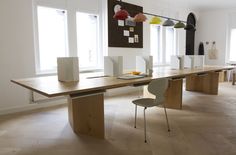 a long table with chairs in an empty room