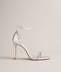 a woman's white high heeled sandal