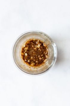 a blender filled with brown liquid on top of a white table