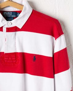 Polo ralph lauren striped rugby in red & white. hand-picked from american rag’s private vintage collection. this regular-fit long-sleeved rugby shirt features a short point collar with a 3 button closure. polo's iconic pony is embroidered on the chest in navy.    condition: used - excellent  brand: polo ralph lauren  era: 1990s    measurements:  marked size: l  length: 27"  chest: 22"  shoulders: 18"    materials: cotton Rugby Vintage, White Hand, American Rag, Lifestyle Shop, Rugby Shirt, Navy Stripes, Hand Picked, Fabric Material, Vintage Collection