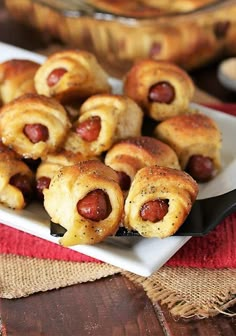 hot dogs wrapped in bread on a plate