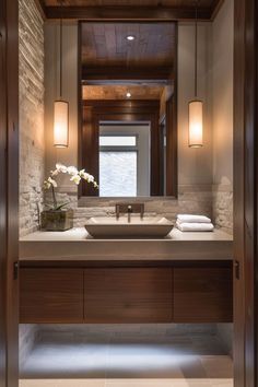 a bathroom with a sink, mirror and lights