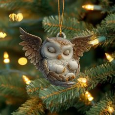 an owl ornament hanging from a christmas tree