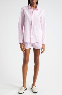 Perky pink stripes rev up your day in a cotton shirt cut in a relaxed profile aligned with new ways of working. 29 1/2" length (size Large) Front button closure Spread collar Curved hem Long sleeves with button cuffs 100% cotton Dry clean or machine wash, line dry Made in Portugal Asian & Pacific Islander Owned/Founded Pink Relaxed Fit Tops With Vertical Stripes, Pink Relaxed Fit Top With Vertical Stripes, Pink Cotton Shirt With Striped Collar, Cotton Shirt With Vertical Stripes For Daywear, Classic Pink Top With Striped Collar, Pink Vertical Stripes Button-up Top, Pink Vertical Striped Button-up Top, Serif Logo, Pacific Islander