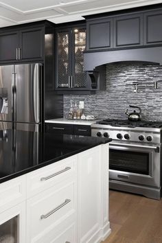 a black and white kitchen with stainless steel appliances