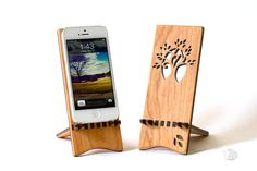 an iphone is sitting on a wooden stand with a cell phone in it's holder