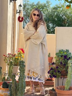 This super soft boiled wool kimono coat is the perfect neutral staple for your wardrobe. This kimono coat is super lightweight yet keeps you warm, and it is wonderfully fun to wear over just about anything! The best part about it is that it goes over all of our PAX dress silhouettes. It flatters every figure and every height. To top it all off, you can wear it on whichever side you prefer as this item is completely reversible, adding even more options to your wardrobe! The use of boiled wool for Oversized Shawl Collar Sweater Coat For Spring, Spring Lagenlook Long Sleeve Poncho, Oversized Long Sleeve Winter Robe, Oversized Beige Lagenlook Outerwear, Oversized Beige Wrap Outerwear, Cream Long Sleeve Fall Kimono, Oversized Bohemian Cream Outerwear, Bohemian Oversized Cream Outerwear, Bohemian Cream Oversized Outerwear