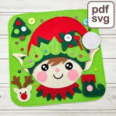 a felt christmas ornament is shown on a green mat with buttons and sequins