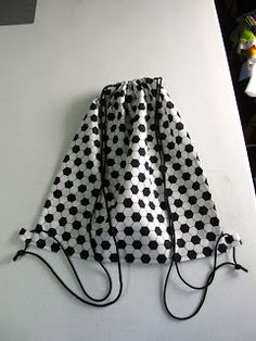 a black and white polka dot bag hanging on the wall