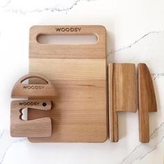 a wooden cutting board with two knives and a knife block on the counter next to it