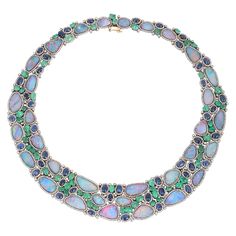 This stunning statement necklace is crafted in 18-karat gold and sterling silver. It is hand set in 70.0 carats opal doublets, 22.65 carats emerald, 27.37 carats blue sapphire and 11.41 carats of diamonds. FOLLOW MEGHNA JEWELS storefront to view the latest collection & exclusive pieces. Meghna Jewels is proudly rated as a Top Seller on 1stDibs with 5 star customer reviews. All items manufactured by us are handmade and can be customized or redesigned. Composition Gold Weight(Gms)-7.2 Silver Weigh Elegant Multi-stone Opal Gemstones, Luxury Opal Pendant Necklace, Luxury Hallmarked Opal Jewelry, Elegant Multi-stone Opal Jewelry, Luxury Oval Opal Necklaces, Luxury Opal Cabochon Jewelry, Elegant Opal Jewelry With Cabochon, Elegant Opal Cabochon Jewelry, Opal Jewelry With Gemstone Accents For Formal Occasions