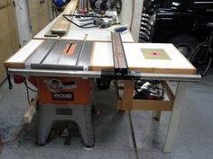 a table saw is sitting on top of a workbench in a garage area