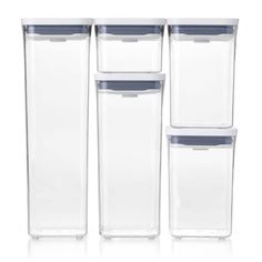 four clear storage containers with lids on each one side and two blue lids on the other