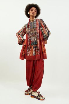 Multi color tunic with geometric prints and embroidery detailing. Paired with drape trouser.
Components: 2
Pattern: Printed
Type Of Work: Tassels, kaudi, mirror
Neckline: Round
Sleeve Type: Flared
Fabric: Tunic: Cotton silk, Trouser: Crepe
Color: Multi Color
Other Details: 
Back tie-up detailing
Gathers detailing
Length:
Tunic: 31.5 Inches
Trouser: 40 Inches
Note: The hair accessory worn by the model is not for sale
Occasion: Wedding - Aza Fashions Geometric Prints, Embroidery Detailing, Print Tunic, Set For Women, Cotton Silk, Aza Fashion, Hair Accessory, Fashion Set, Geometric Print