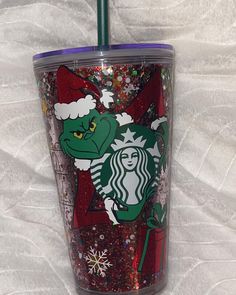 the starbucks cup is decorated with glitter and has a dragon on it's side