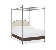 an iron bed frame with white sheets and pillows on the bottom, in front of a white background