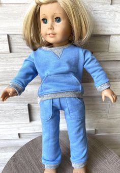 a doll with blonde hair and blue pajamas