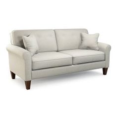 a white couch with two pillows on it