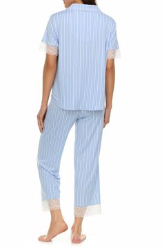 Drift off into dreamland in these seriously soft striped pajamas that pair a lace trimmed button-up shirt with matching cropped elastic-waist pants. 25" inseam (size Small) Top has front button closure; notched collar; short sleeves Pants have elastic waist 95% polyester, 5% spandex Machine wash, tumble dry Imported Striped Spring Sleepwear For Bedtime, Spring Striped Sleepwear For Bedtime, Striped Sleepwear For Spring Sleepover, Spring Striped Sleepwear For Loungewear, Striped Sleepwear For Spring Loungewear, Striped Sets For Spring Loungewear, Casual Blue Lace-trim Sleepwear, Casual Blue Sleepwear With Lace Trim, Striped Pajamas