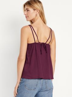 scoop neck adjustable straps tie-back strap shirred detail loose fit hits below waist models are approx.  5'9" and wear sizes s (4), l (12), and xl (18) Spring Strappy Tie-back Tops, Spring Strappy Tie Back Tops, Spring Strappy Back Top With Tie Detail, Beach Tops With Knotted Tank Straps, Spring Strappy Back Tie Tank Top, Beach Tops With Knotted Straps, Spaghetti Strap Top With Tie Straps For Day Out, Summer Chic Tops With Strappy Back, Trendy Camisole With Straps For Day Out