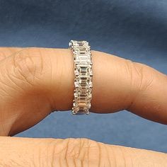 a woman's hand with a diamond ring on it