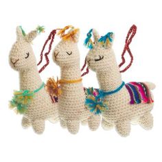 three crocheted llamas hanging from strings