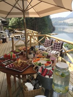 a table full of food and drinks on a deck