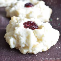 three cookies with cranberry toppings on top of them sitting on a table