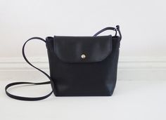 Mini black leather crossbody bag by Handmadeso on Etsy Black Soft Leather Satchel Flap Bag, Classic Black Crossbody Flap Bag, Black Leather Flap Bag, Black Shoulder Bag With Snap Closure For Work, Black Flap Shoulder Bag For Everyday, Black Saddle Bag With Magnetic Closure For Formal Occasions, Black Flap Bag With Magnetic Closure For Work, Black Classic Shoulder Bag With Fold Over Clasp, Black Formal Saddle Bag With Magnetic Closure