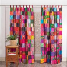 the curtains are colorfully colored and have different patterns on them, as well as a potted plant