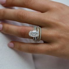 a woman's hand with two rings on it