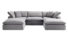 a gray sectional couch with pillows on it's back and the seat folded out