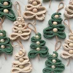 several crocheted ornaments are arranged on a marble counter top with string and beads