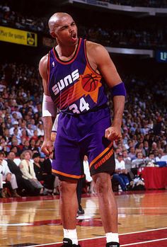 a basketball player standing on the court with his mouth open in front of an audience