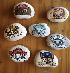 six paw patrol painted rocks on a wooden table