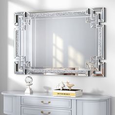 a white dresser with a mirror on top of it