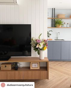 a flat screen tv sitting on top of a wooden table