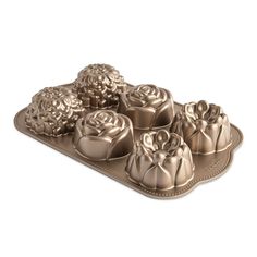 a metal tray filled with chocolates on top of a white table