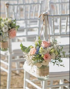 the chairs are decorated with flowers and burlocks for an outdoor wedding ceremony or reception