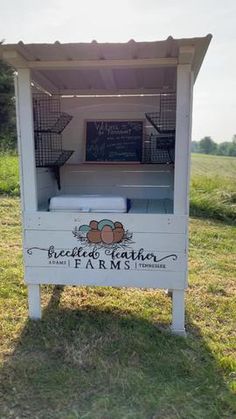 an outdoor food stand that is painted white and has the words breaded featherery farms written on it